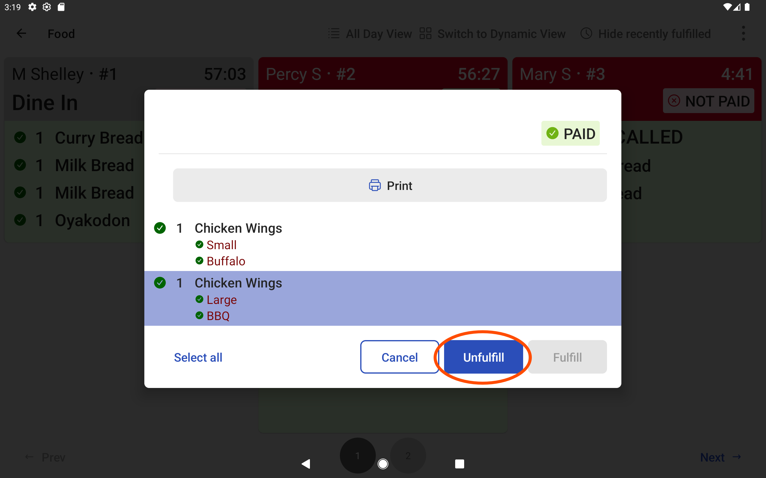 The KDS device with ticket dialog for unfulfilling an item or ticket, emphasizing the Unfulfill option.